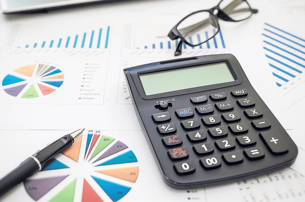 A calculator and a pile of paper.