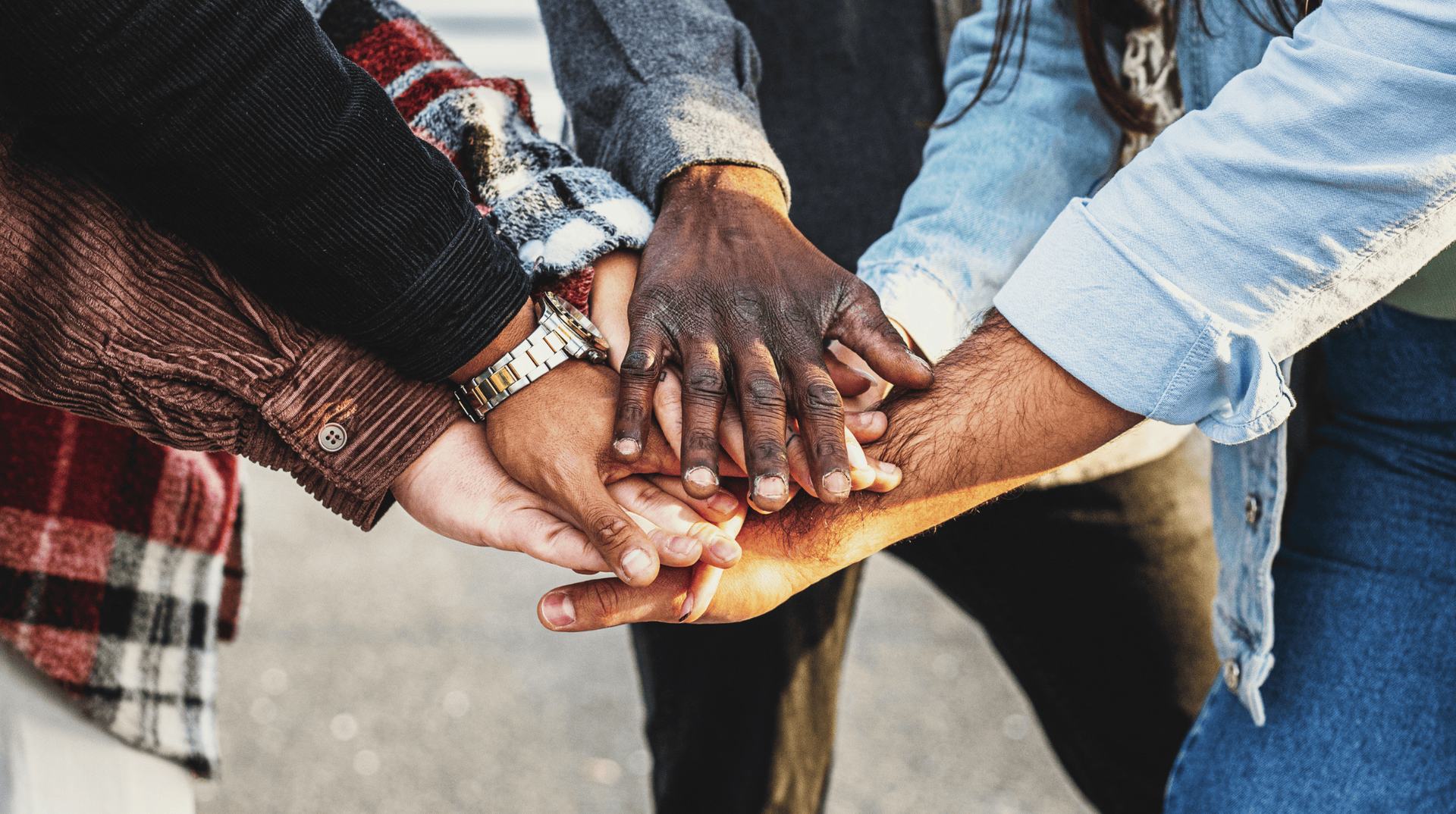 A group of hands touching in a circle.